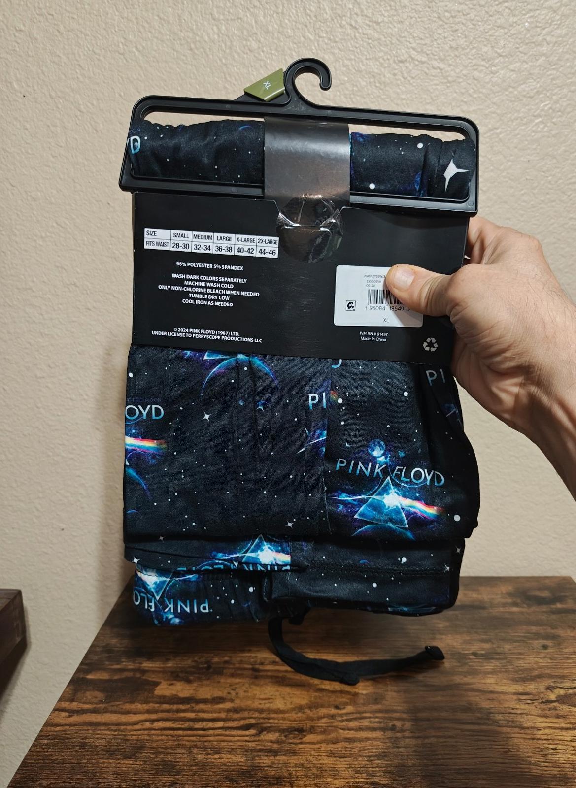 Black sleep pants with galaxy print, XL size label and care tag visible