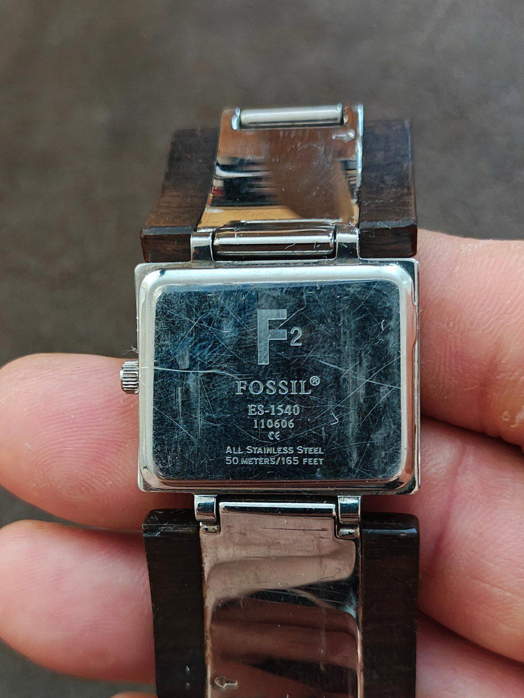 Ladies Fossil watch case back labeled ES-1540, silver-tone steel, brown wooden band