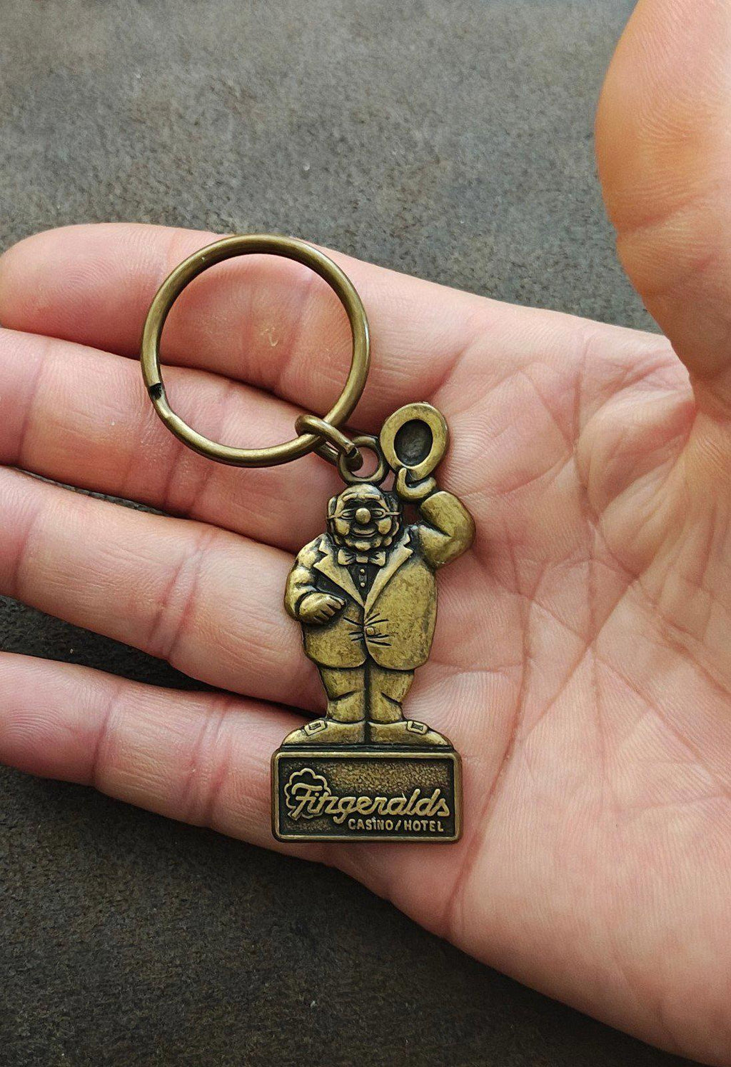 Gold metal keychain with Mr. O’Lucky figure and Fitzgerald’s Casino Hotel nameplate