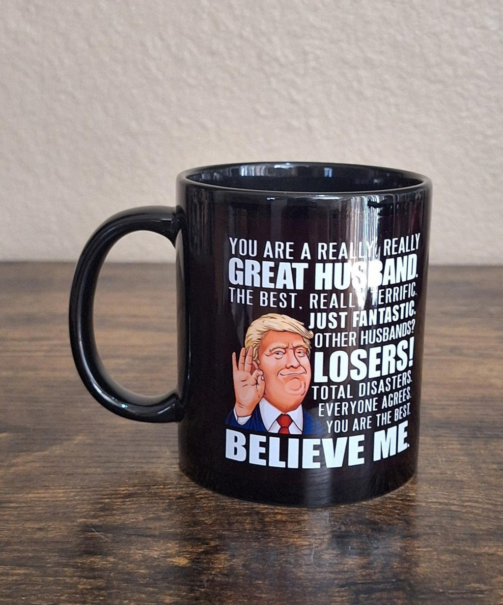 Black ceramic 11 oz mug angled view, showing "Great Husband" and cartoon portrait