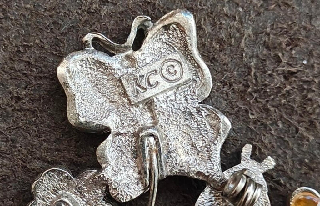 KC signature mark on silver-tone bouquet brooch back