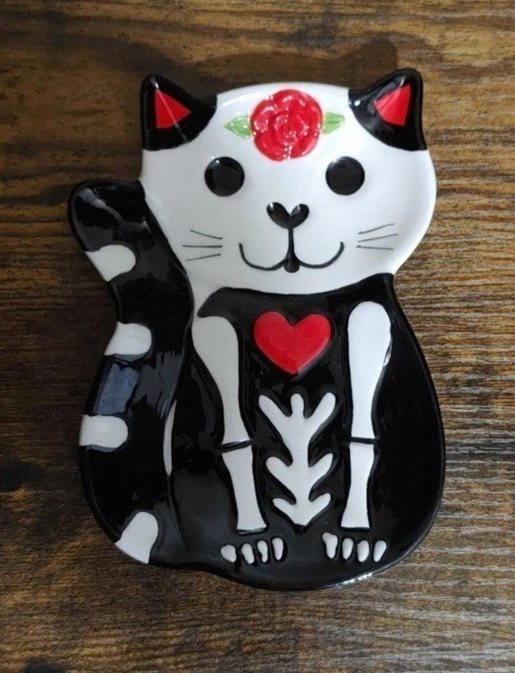 Black-and-white cat trinket plate with red flower crown and red heart emblem