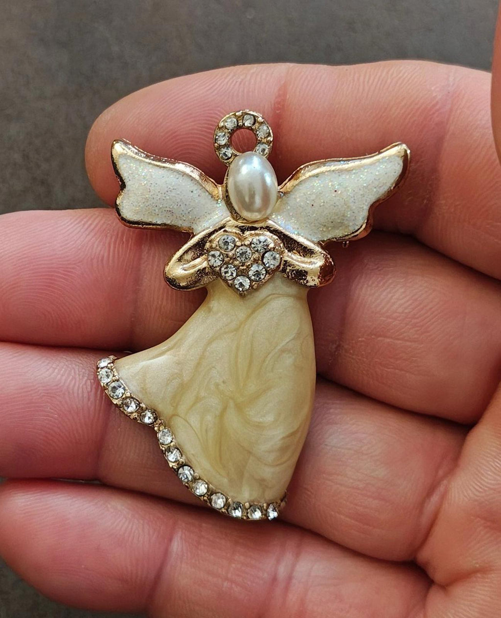 Gold-tone angel brooch with pearlized enamel dress, light blue wings, rhinestone trim