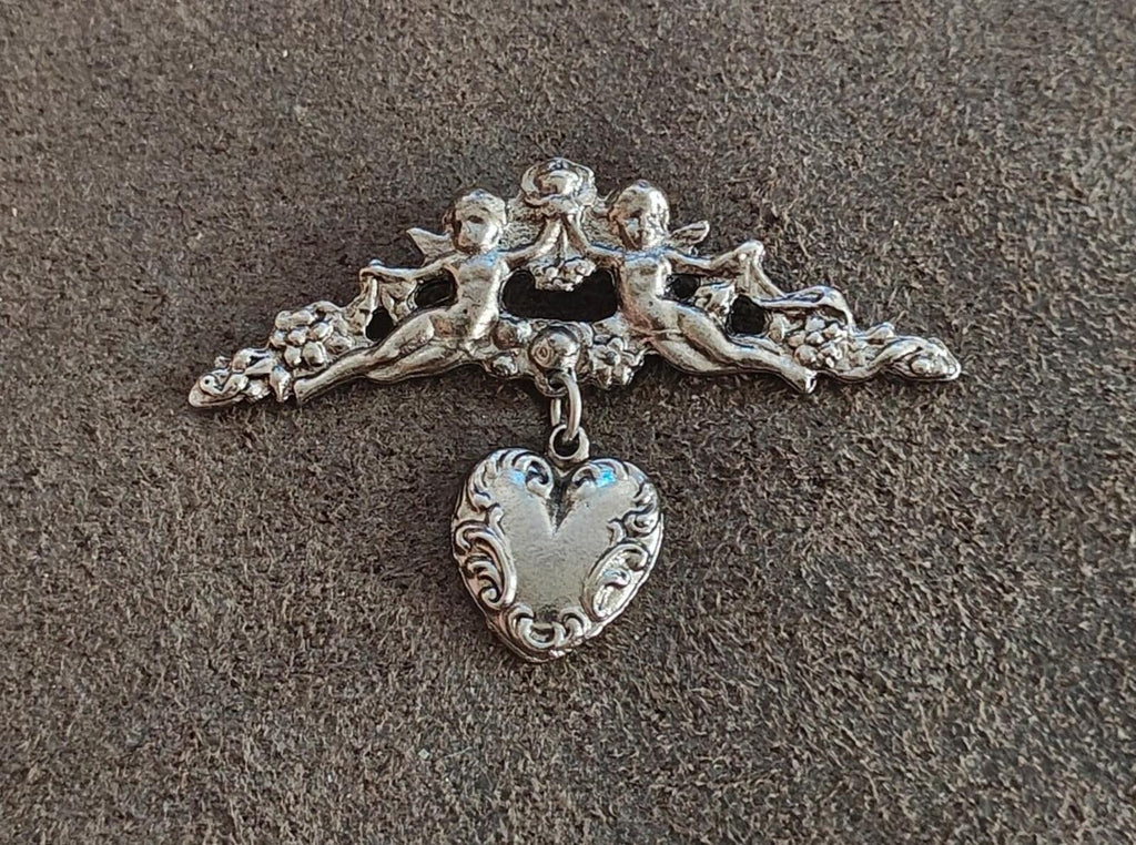 1980s Silver Tone Renaissance Style Cherub Brooch With Dangling Heart Charm