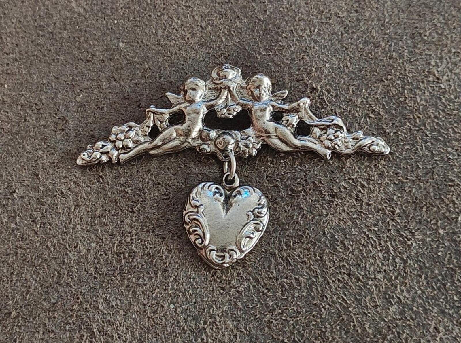 1980s Silver Tone Renaissance Style Cherub Brooch With Dangling Heart Charm