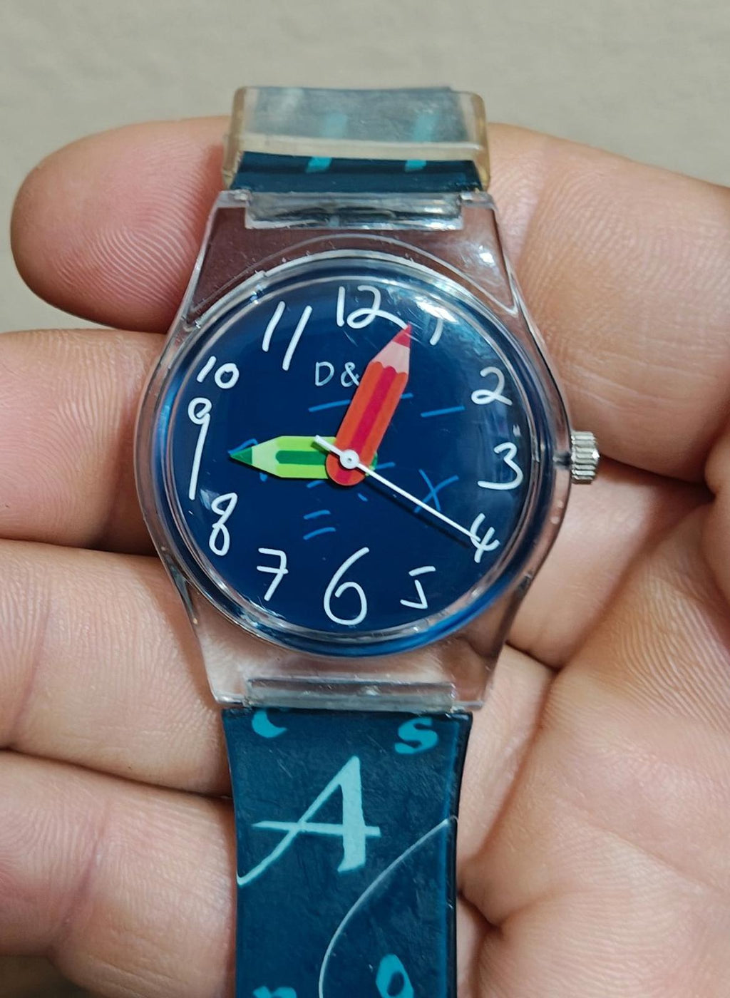 Blue unisex teacher watch with round blue dial, red hands, and printed number strap