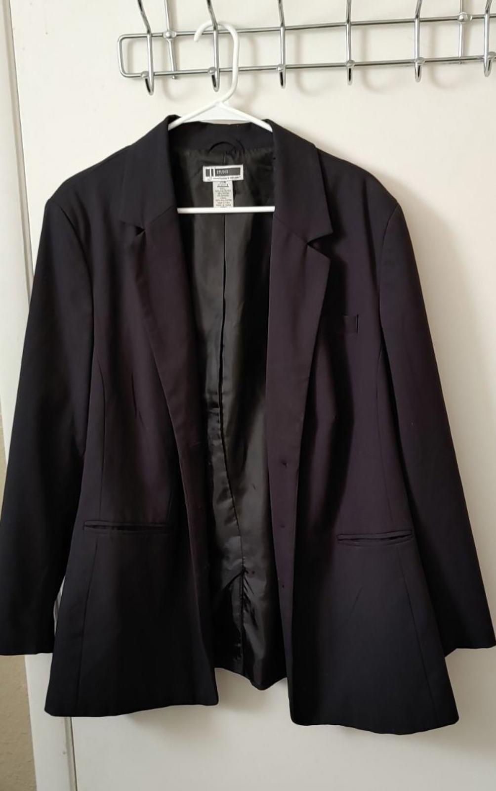 Black blazer with notched lapels, flap pockets, and button front.