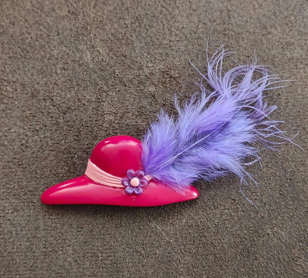 Red hat brooch with lavender feather plume and blue flower embellishment