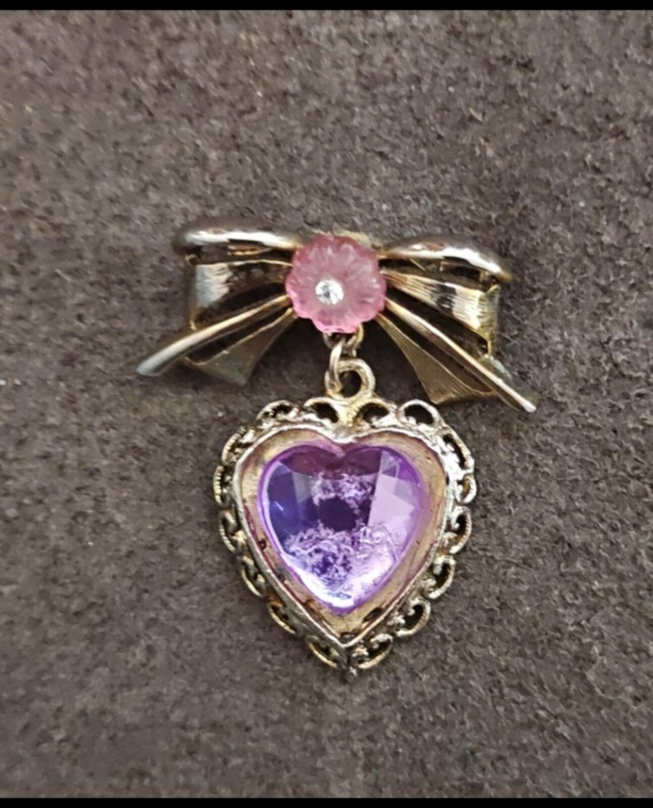 1980s Gold Tone Bow With Pink Flower & Filigree Edged Purple Stone Heart Brooch