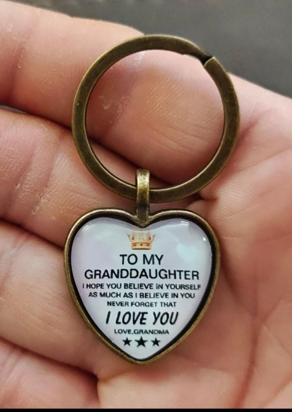 Brass-tone keychain with white heart pendant engraved “To My Granddaughter” and “I Love You”
