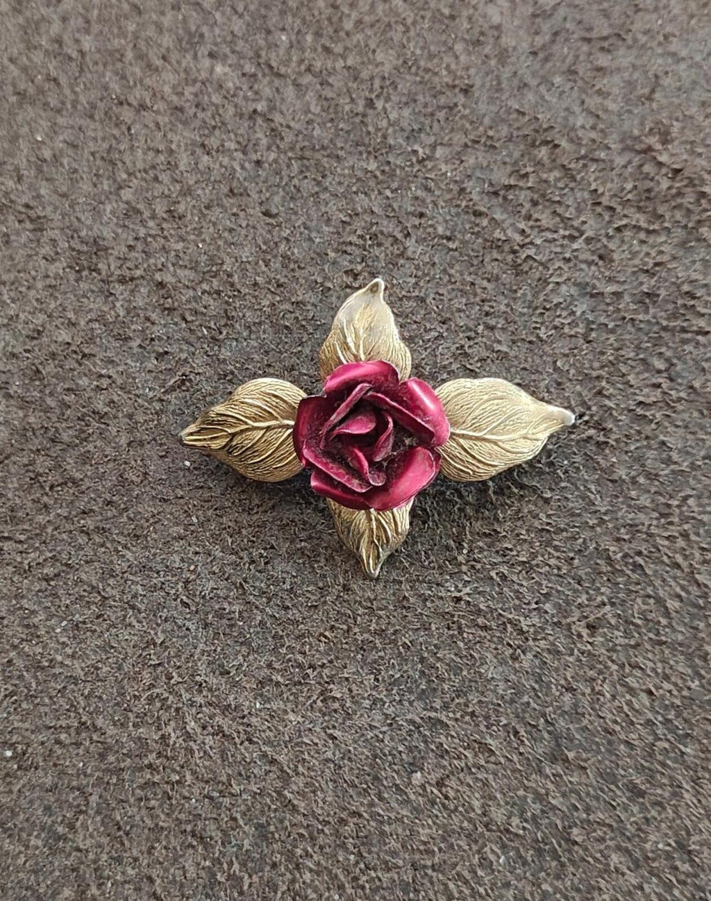 Gold-tone rose enamel brooch with red textured flower and four leaf details
