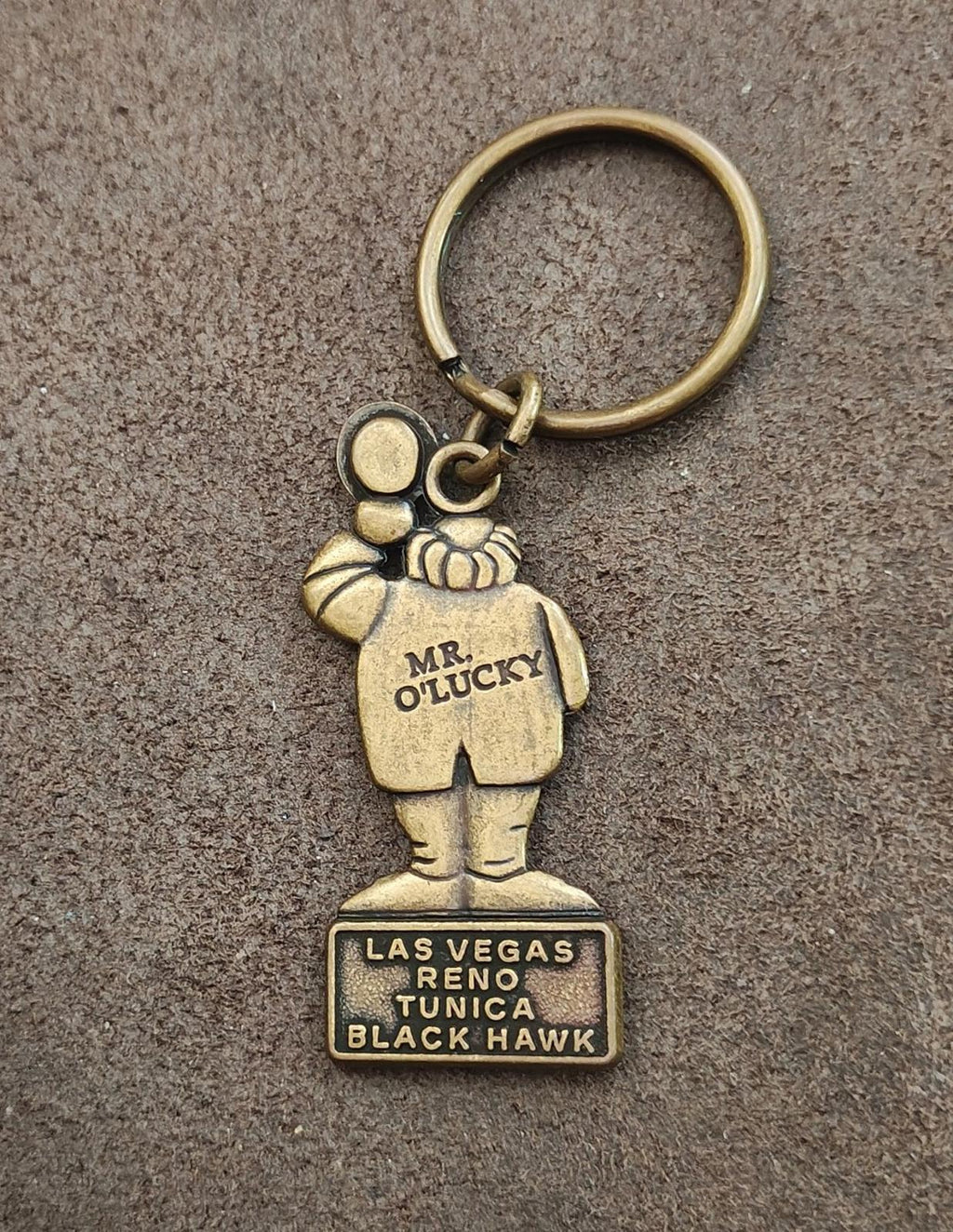 Gold keychain charm of Mr. O’Lucky with “LAS VEGAS RENO TUNICA BLACK HAWK” panel
