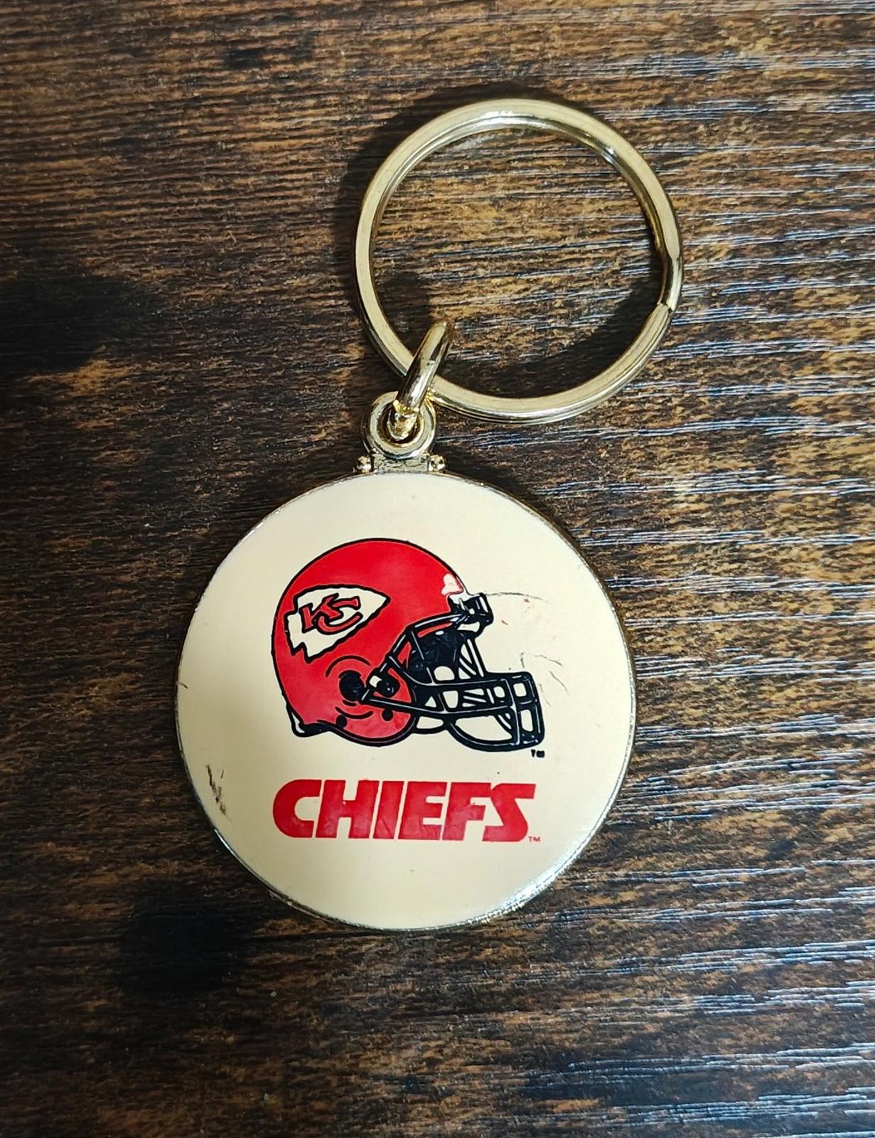 Round Kansas City Chiefs helmet keychain medallion with gold ring and red team logo
