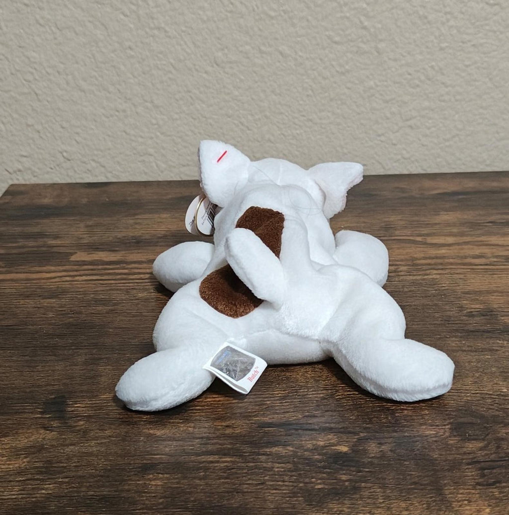 White plush dog with brown face patches and red Ty heart tag, tags visible
