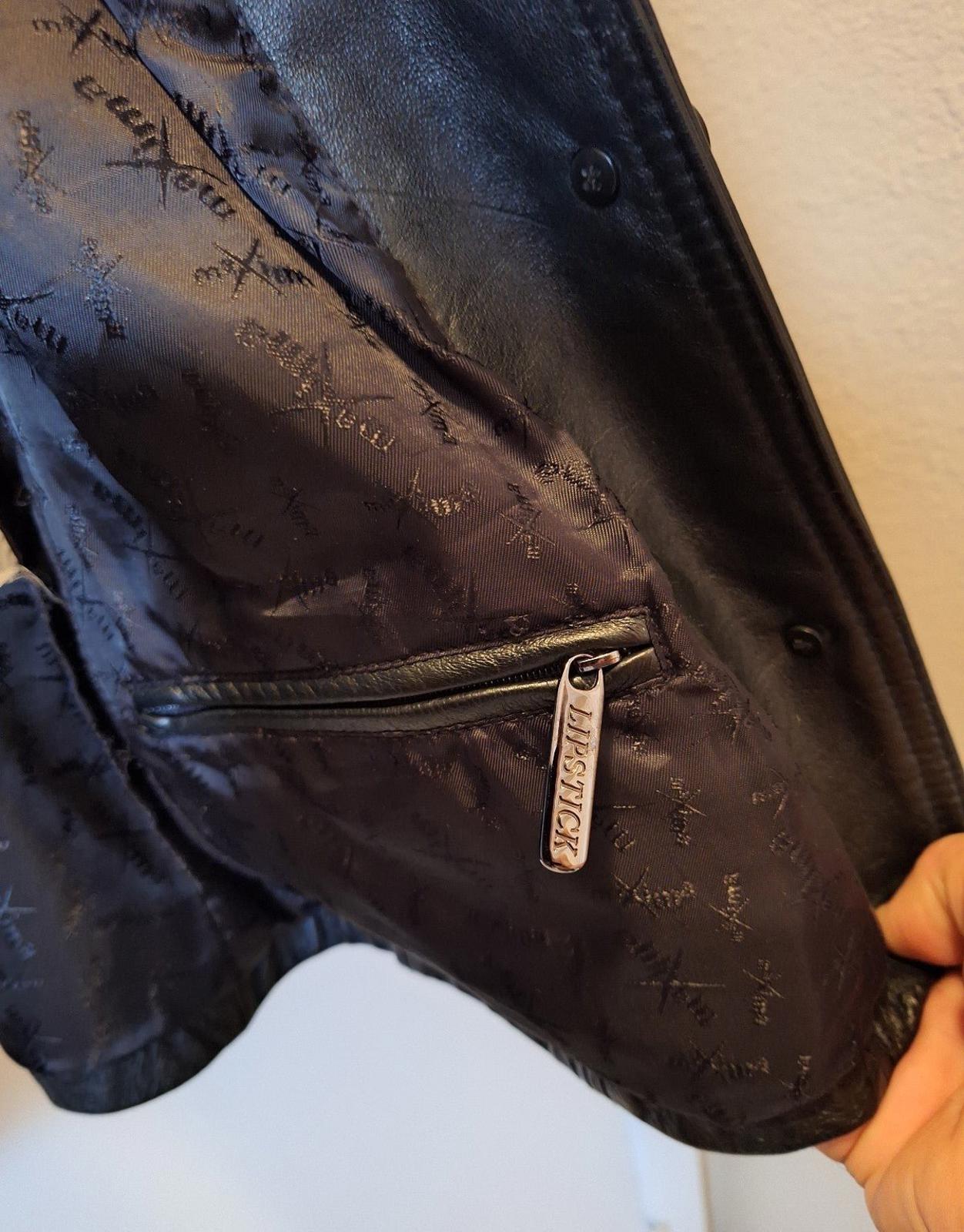Close-up of patterned lining and metal zipper pull at jacket pocket opening