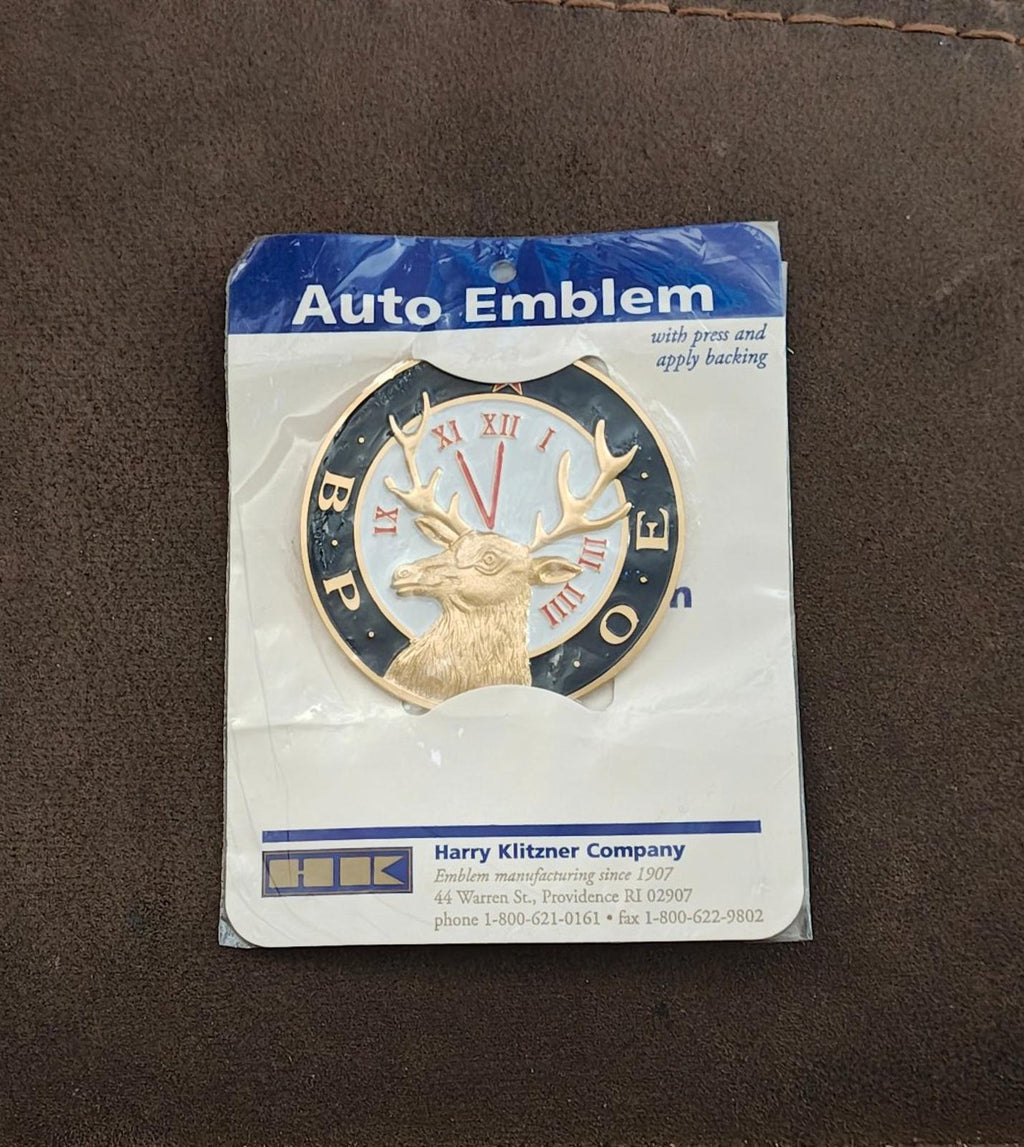 Sealed auto emblem package showing blue deer clock emblem with gold antlers