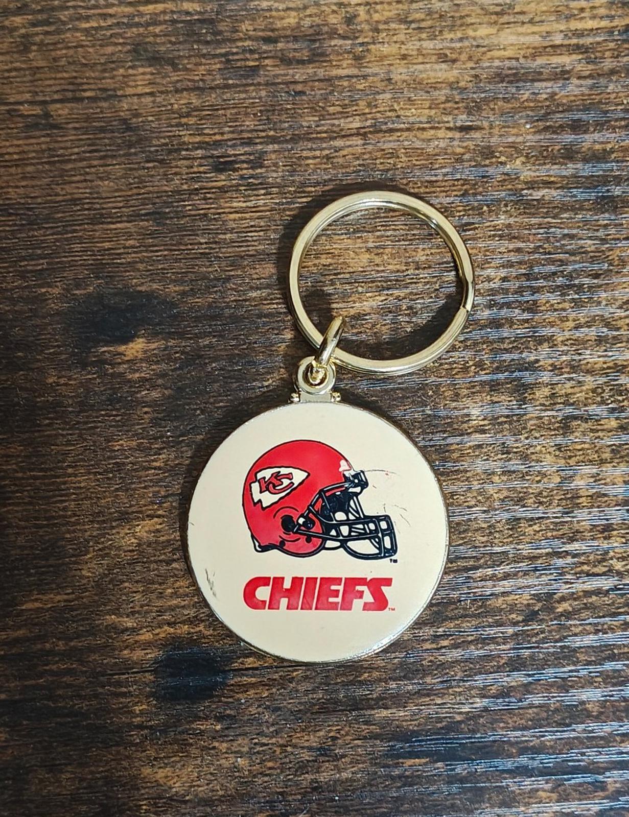 Round Kansas City Chiefs keychain medallion with gold ring and red helmet logo face