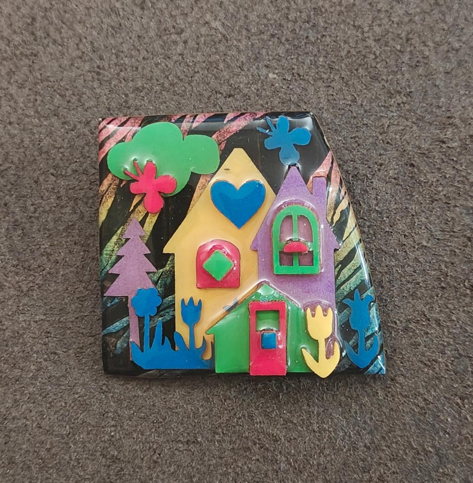 Colorful enamel house scene pin with blue accents, green roof, and red door details