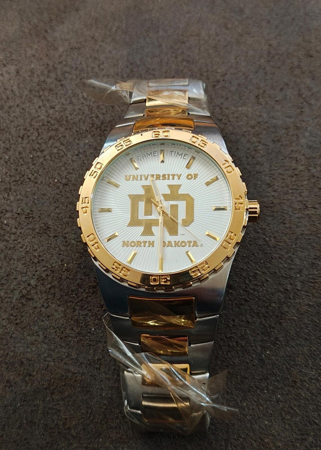 Gold and silver sports watch with white dial and North Dakota logo, full front view