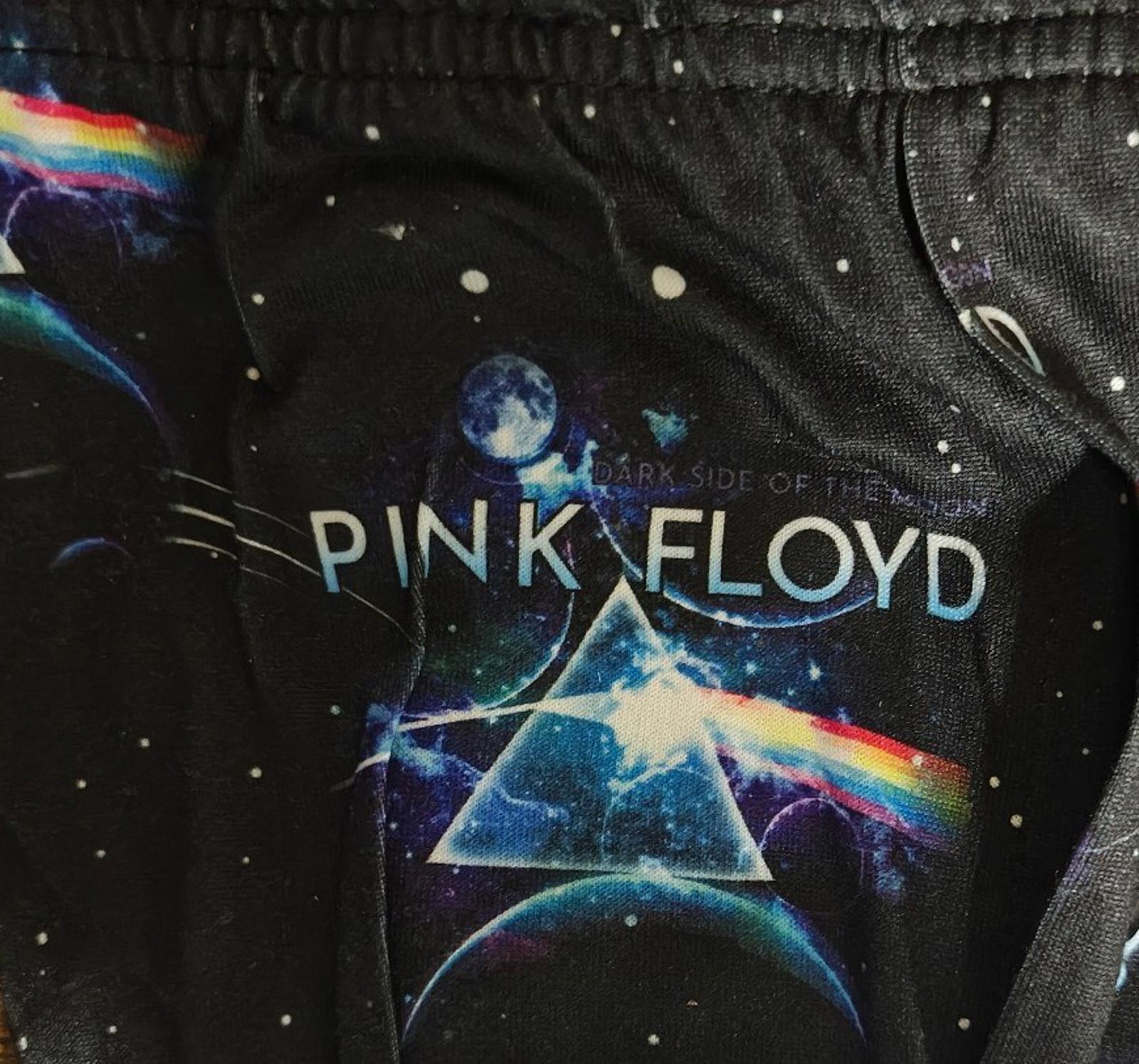 Black sleep pants close-up with galaxy print and large rainbow-tinted logo