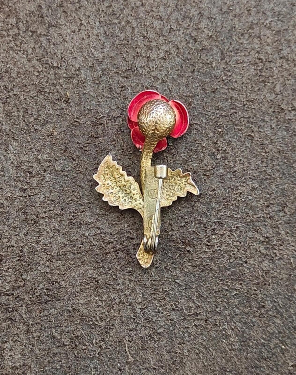 Red enamel rose brooch with gold-tone pin clasp and clear rhinestone center