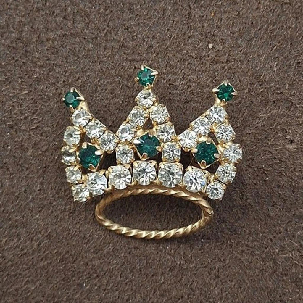 Crown tiara rhinestone brooch featuring green accents and clear stones, gold-tone base
