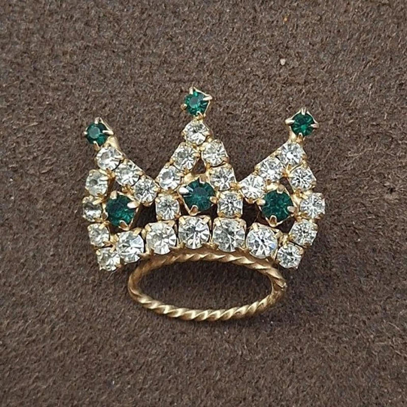 Crown tiara rhinestone brooch featuring green accents and clear stones, gold-tone base