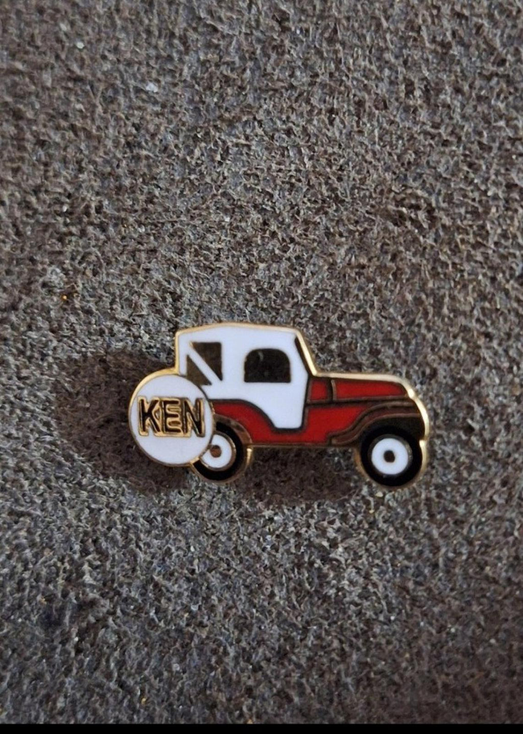 Jeep truck enamel pin with KEN on spare tire, white cab and red body, gold edges