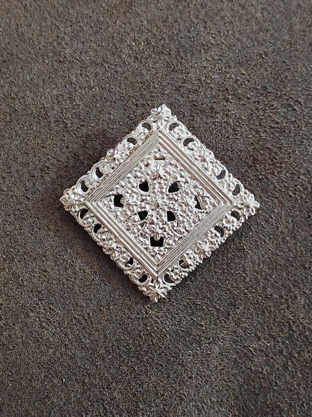 Silver-tone square filigree scarf clip with openwork floral pattern and raised detailing