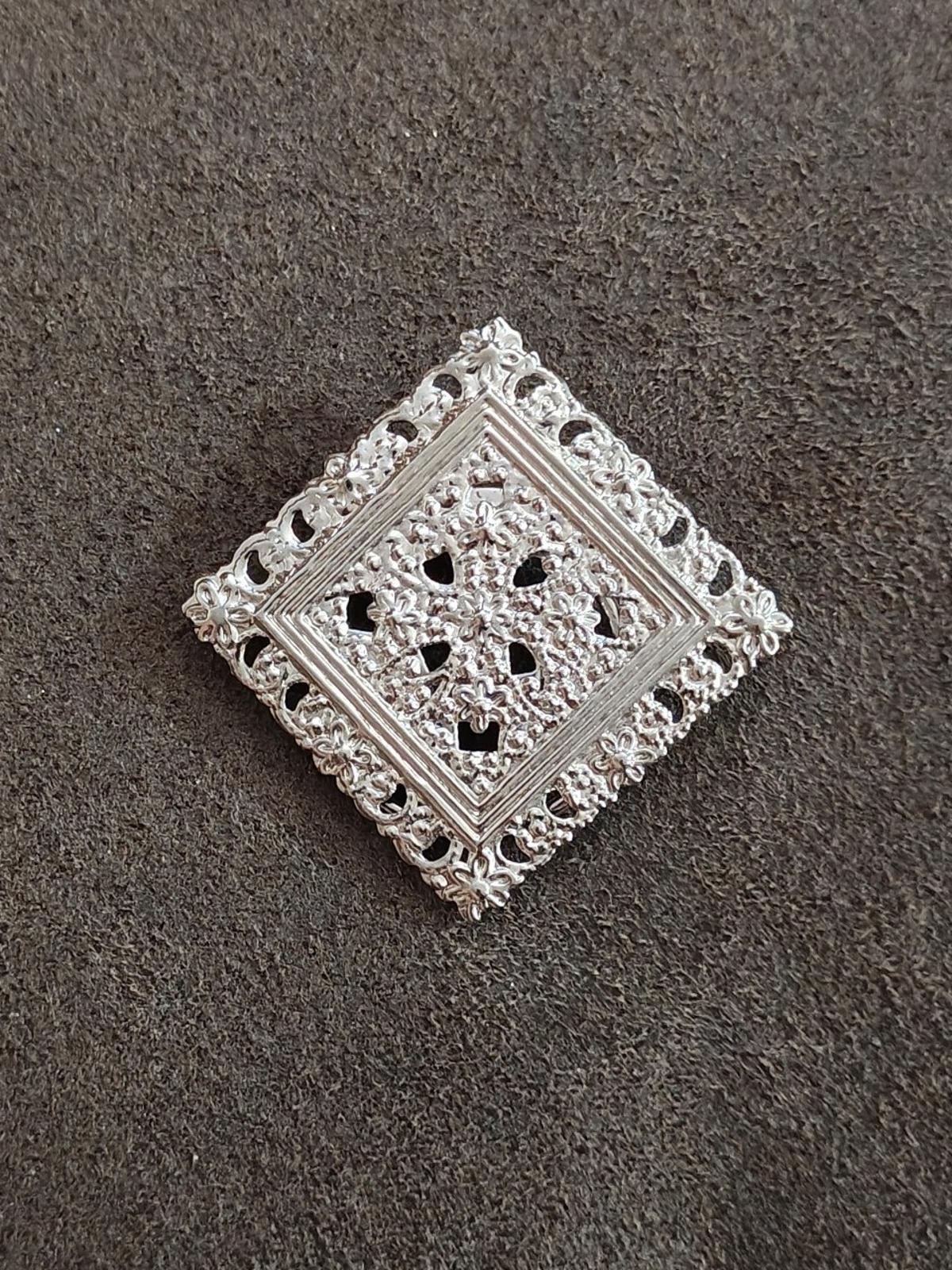 Silver-tone square filigree scarf clip with openwork floral pattern and raised detailing
