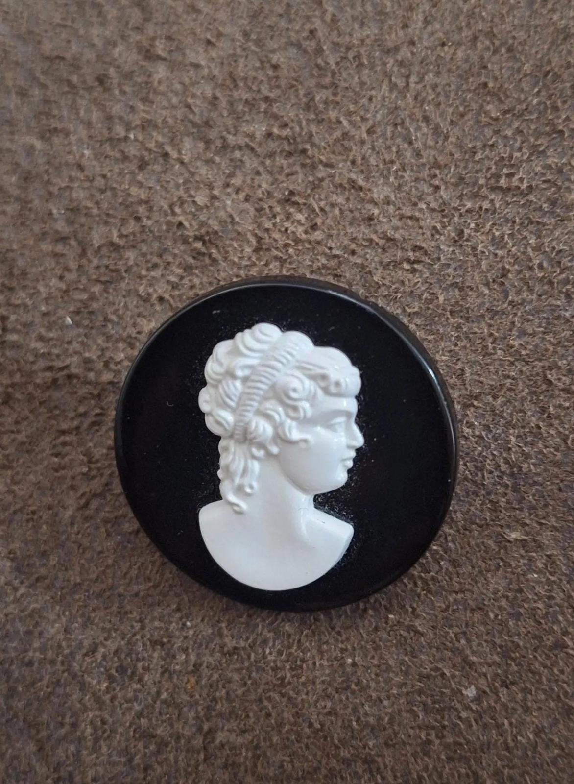 Black round cameo brooch with detailed white profile woman face relief