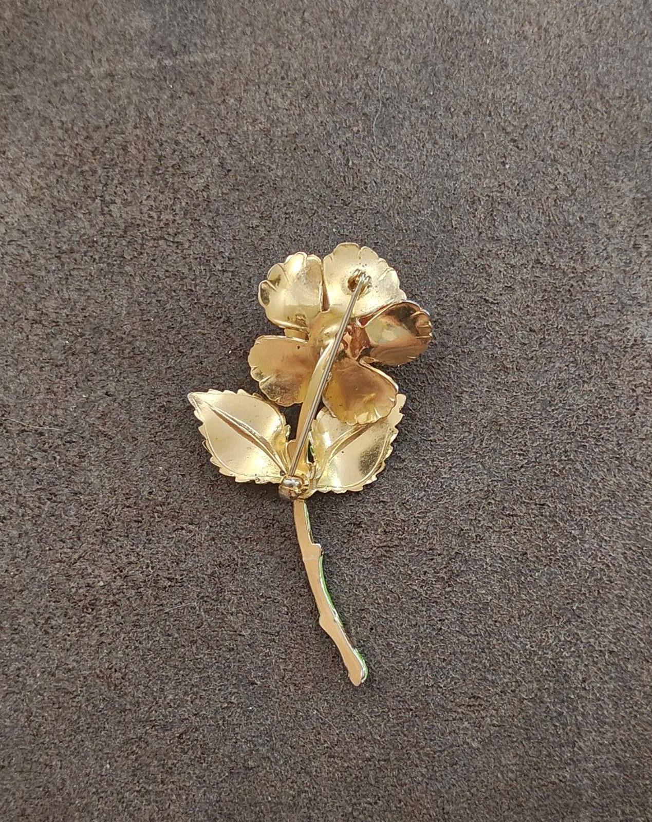 Gold-tone enamel rose and leaf pin with stem, flower detail viewed from the back