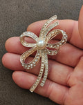 1980s Silver Tone Ribbon Bow With Clear Rhinestones & Large Faux Pearl Brooch