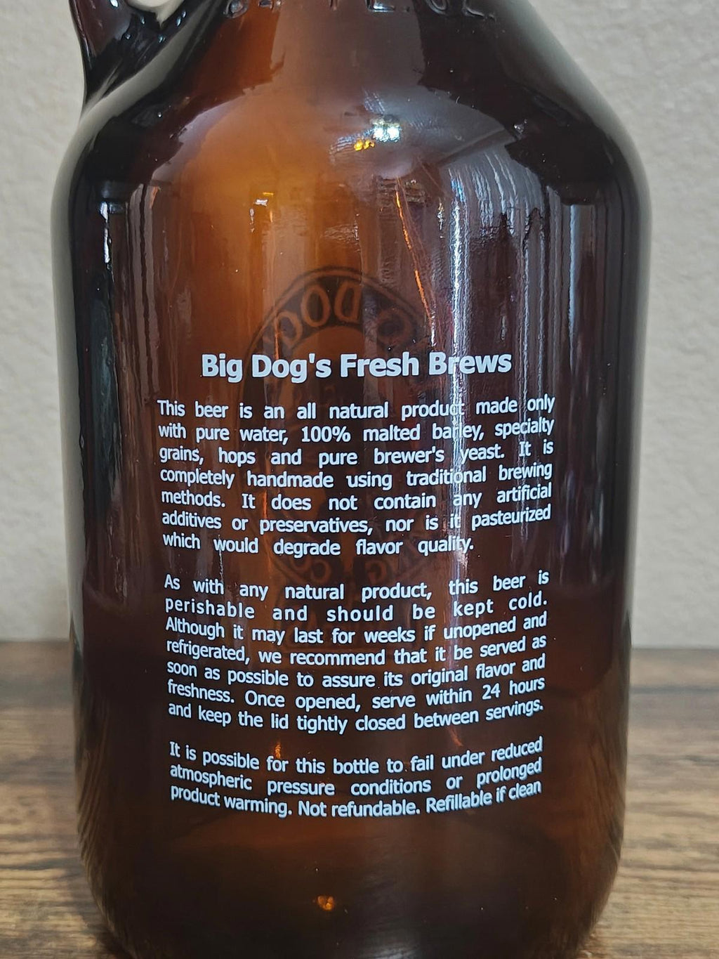 Amber glass jug back label with “Big Dog's Fresh Brews” text