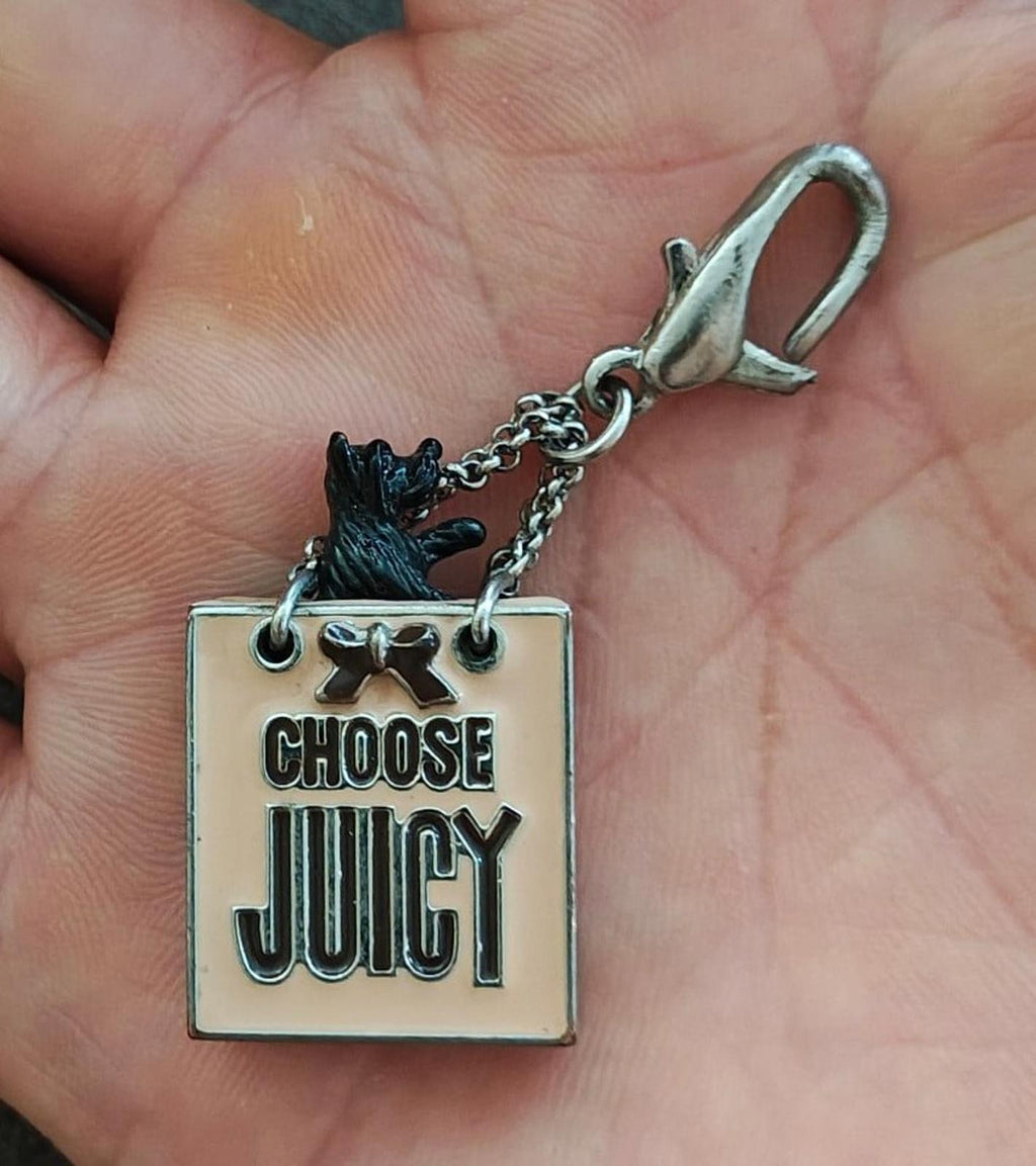 Juicy Couture bag charm with dog icon, "CHOOSE JUICY" text, and chain with clasp
