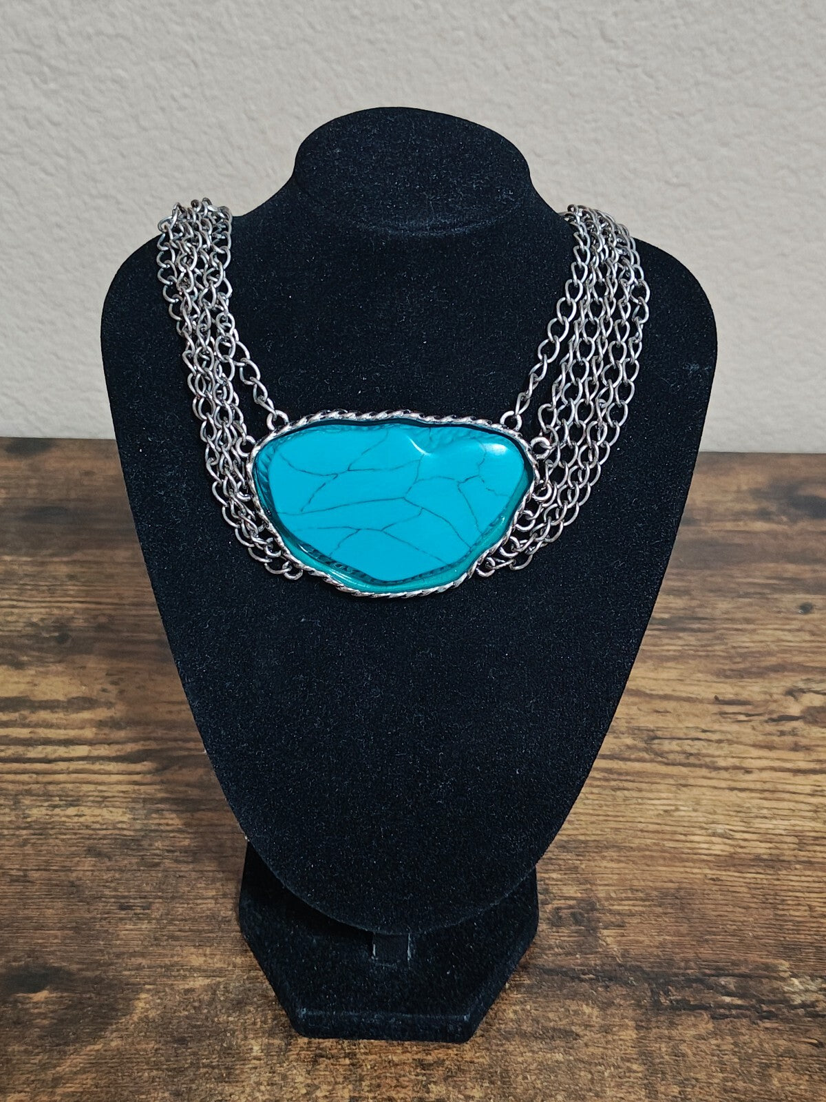 Silver Tone Multi Strand Chain Statement Necklace With a Faux Turquoise Stone
