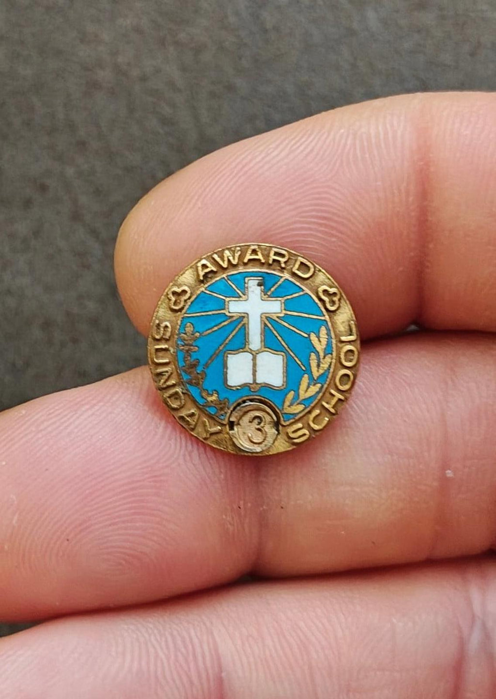 Vintage gold-tone Sunday School award pin with blue enamel cross, laurel, and "AWARD" text