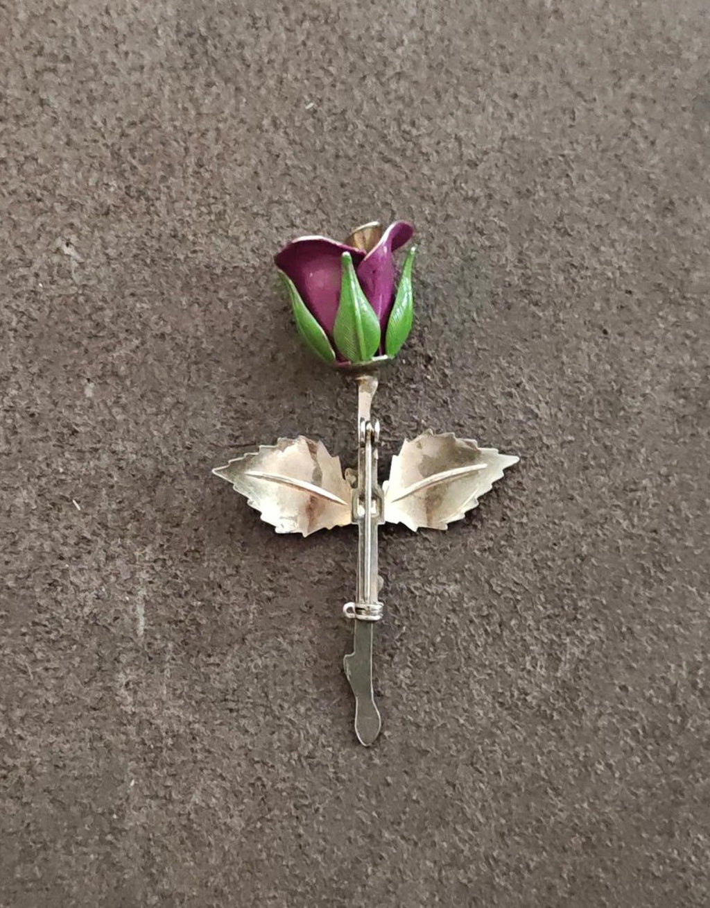 Rose brooch front with purple enamel flower and green accents, silver setting