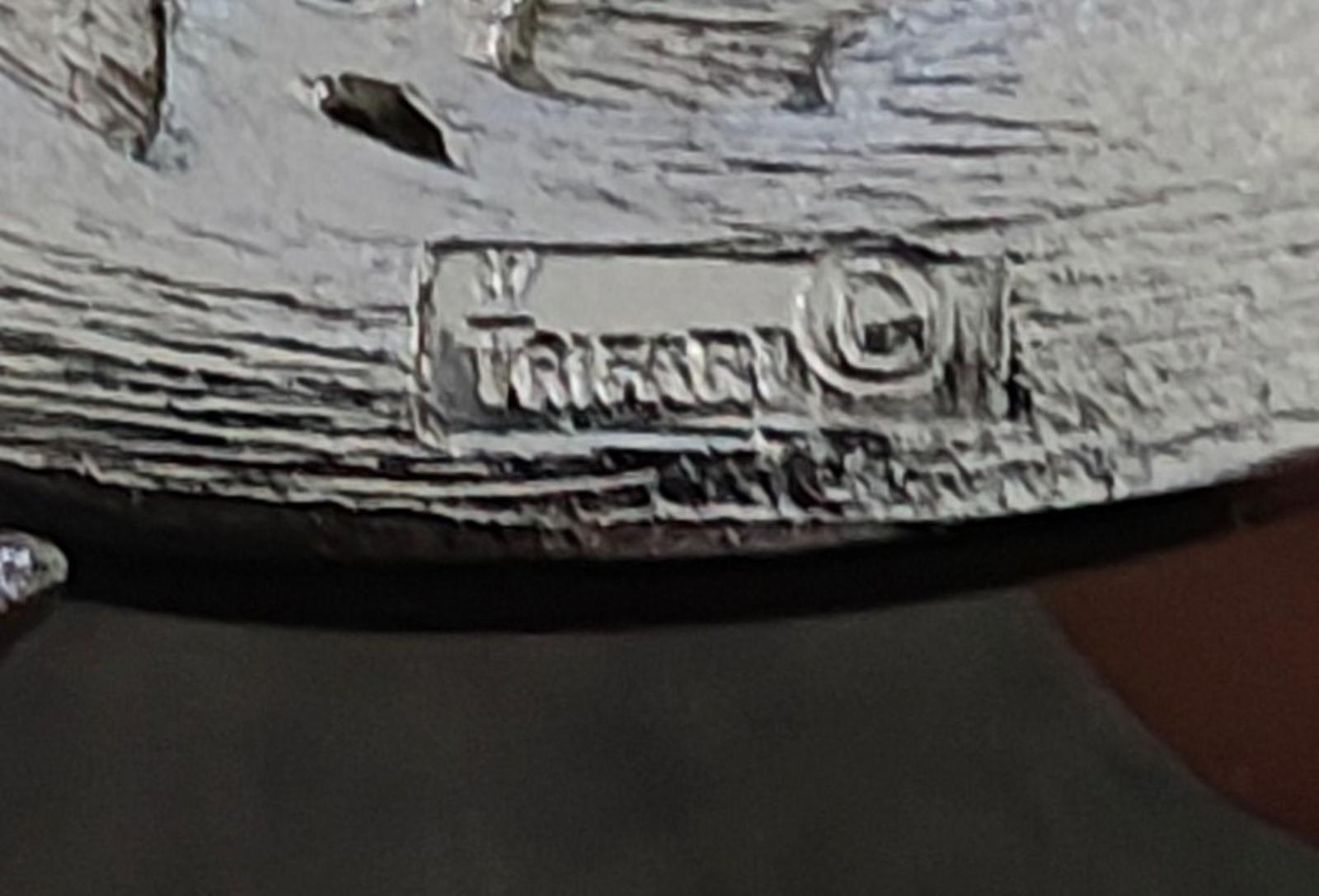 Trifari hallmark on silver-tone brooch back, stamped crown and lettering