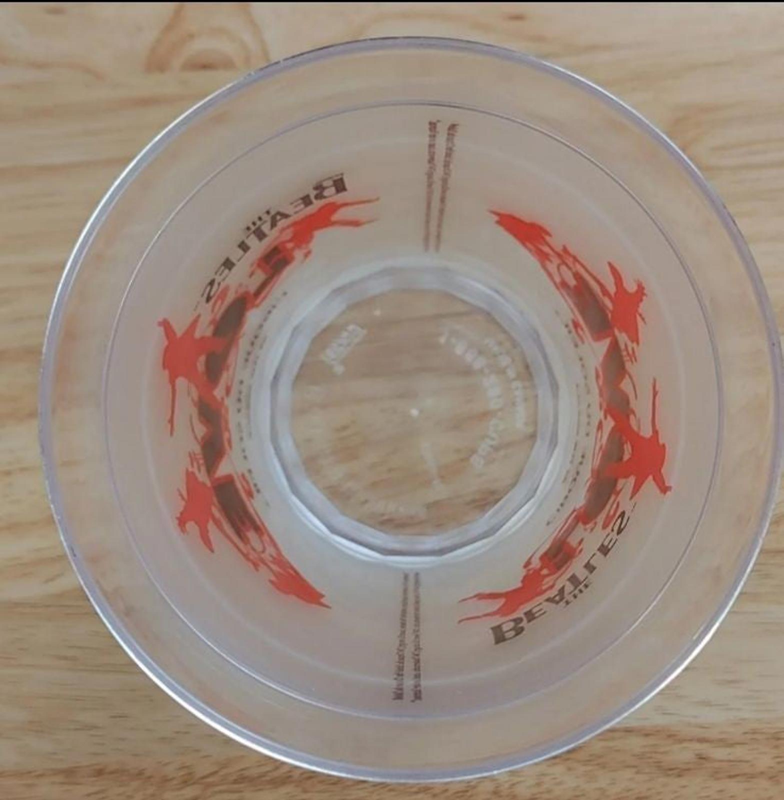 Clear plastic tumbler lid view from above with red LOVE performer silhouettes