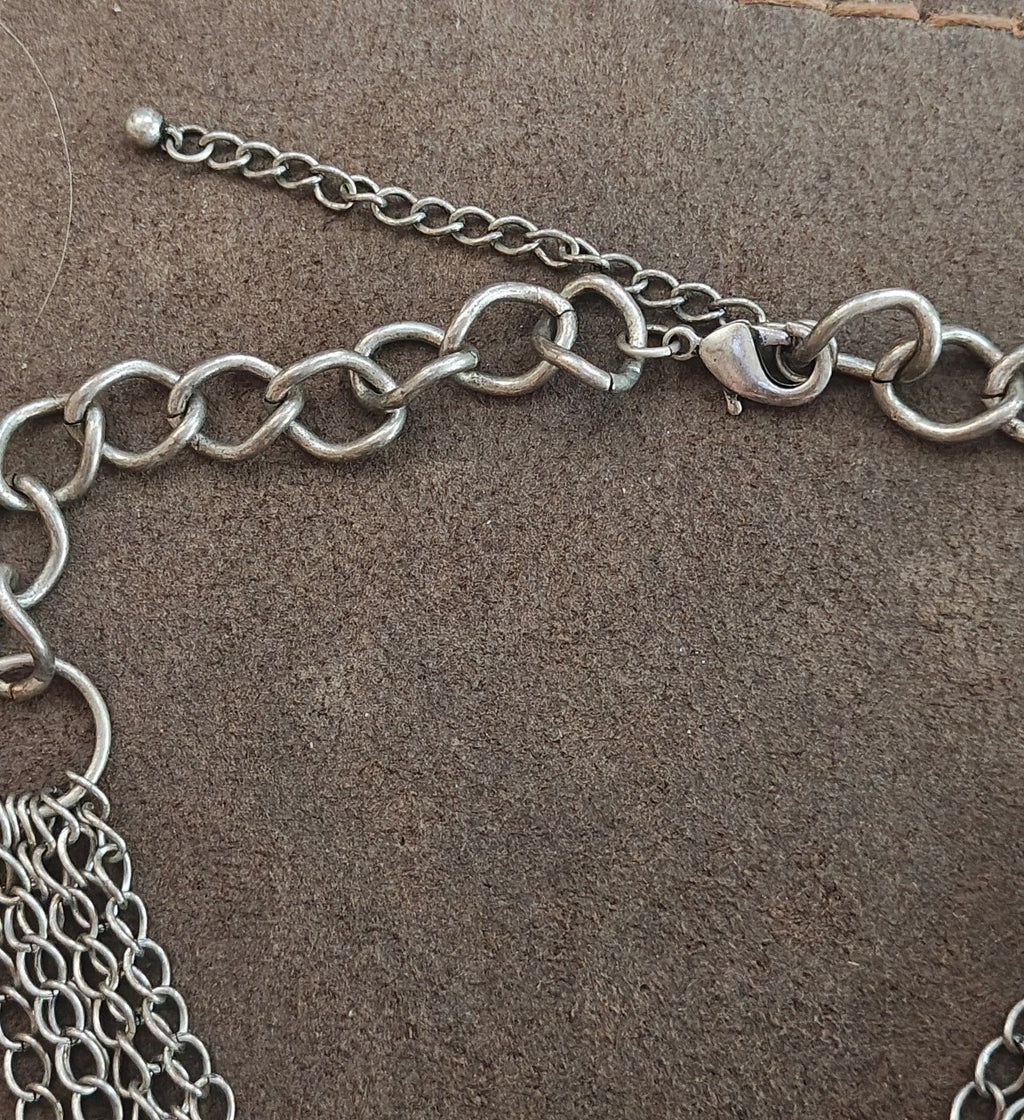 Silver Tone Multi Strand Chain Statement Necklace With a Faux Turquoise Stone