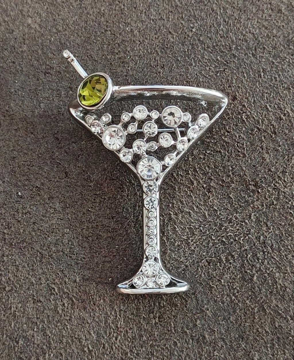Silver-tone martini glass brooch with green rhinestone accent and glittering crystal base
