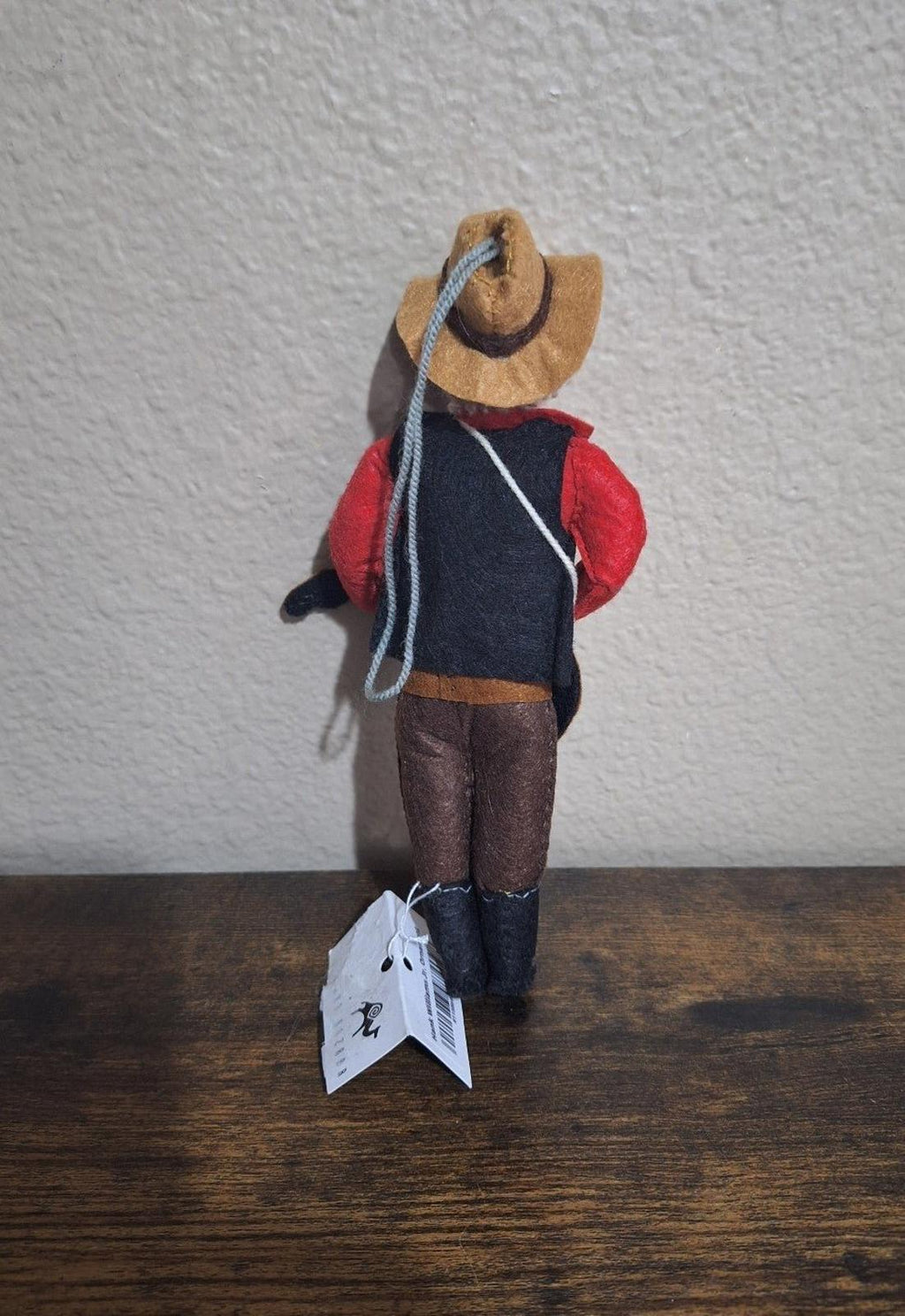 Felt and wool musician ornament side view with red jacket, cowboy hat, and guitar