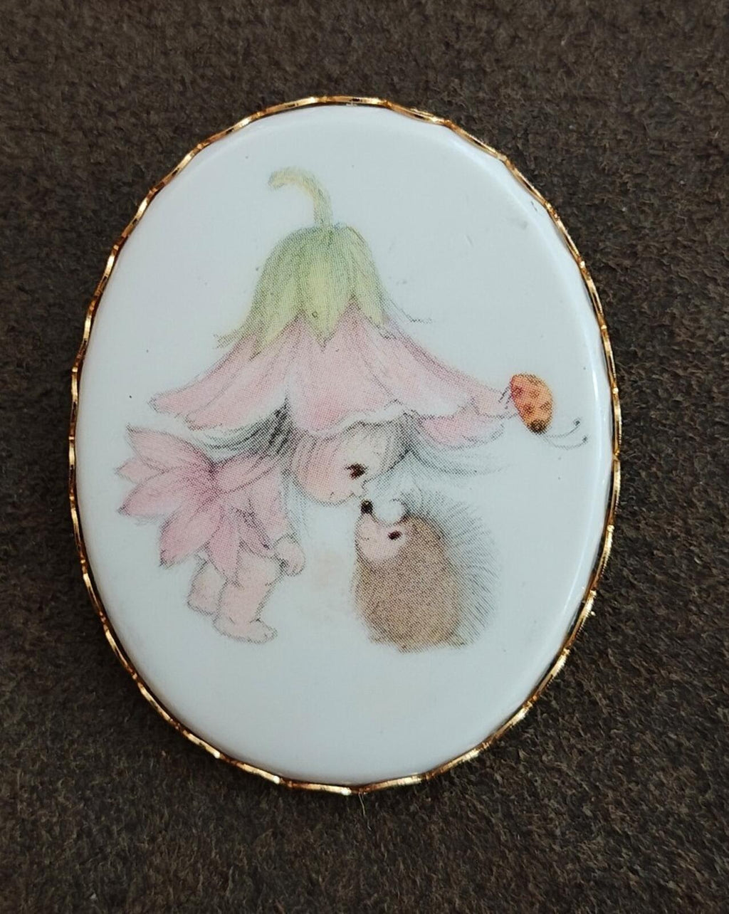 Oval gold-tone enamel cameo brooch with painted pixie girl and small brown rabbit