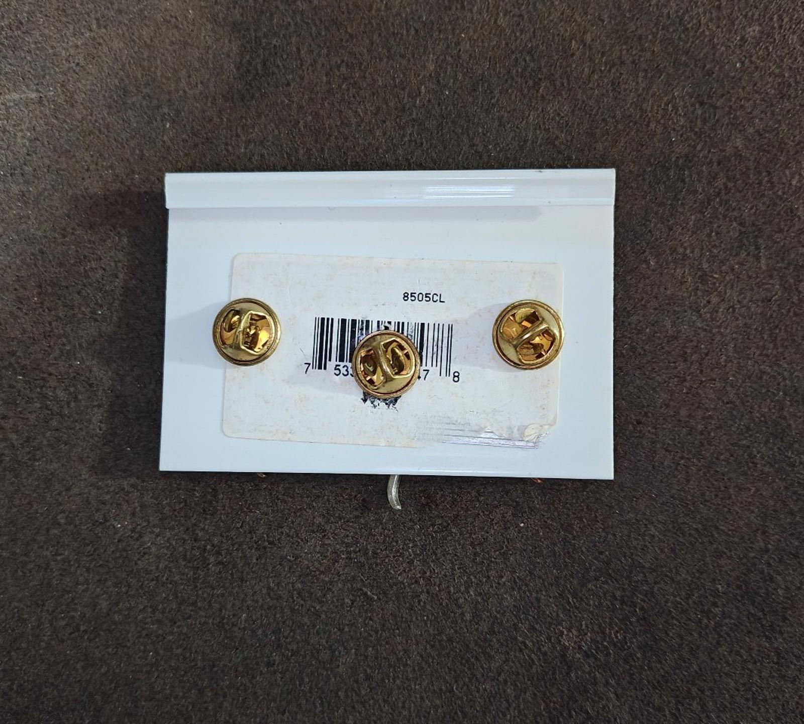 Back of cat pin set card with three gold clasp posts and barcode label