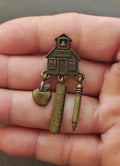 Brass schoolhouse teacher theme dangle pin with rulers, pencil and apple charm