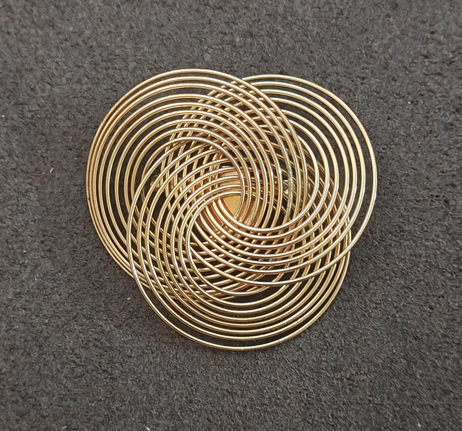 Gold tone wire spiral brooch with layered concentric rings, top view