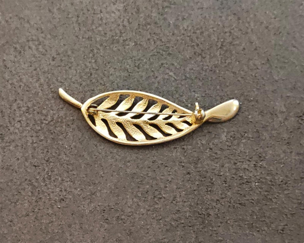 Gold tone leaf brooch with openwork filigree feather motif, pin end visible