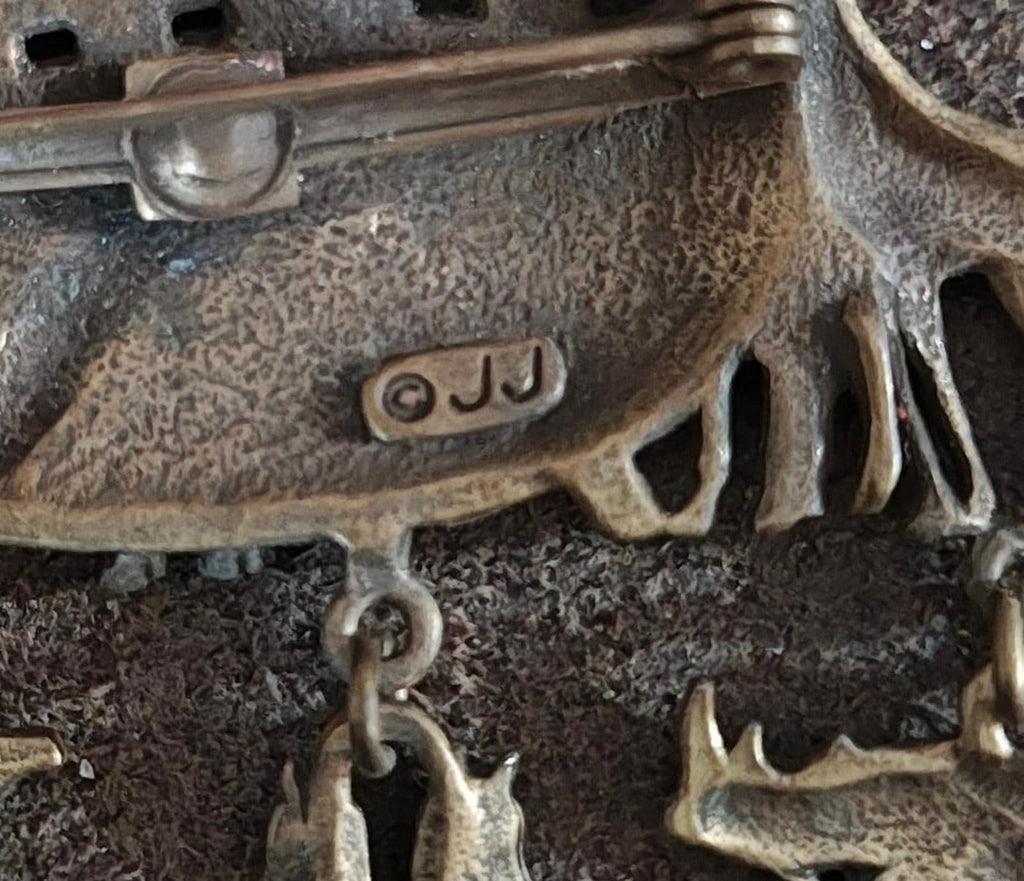 Gold-toned close-up of Noah’s Ark brooch pin clasp with stamped maker mark
