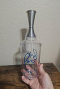 Clear plastic souvenir cocktail shaker with metal spout and blue Paris lettering